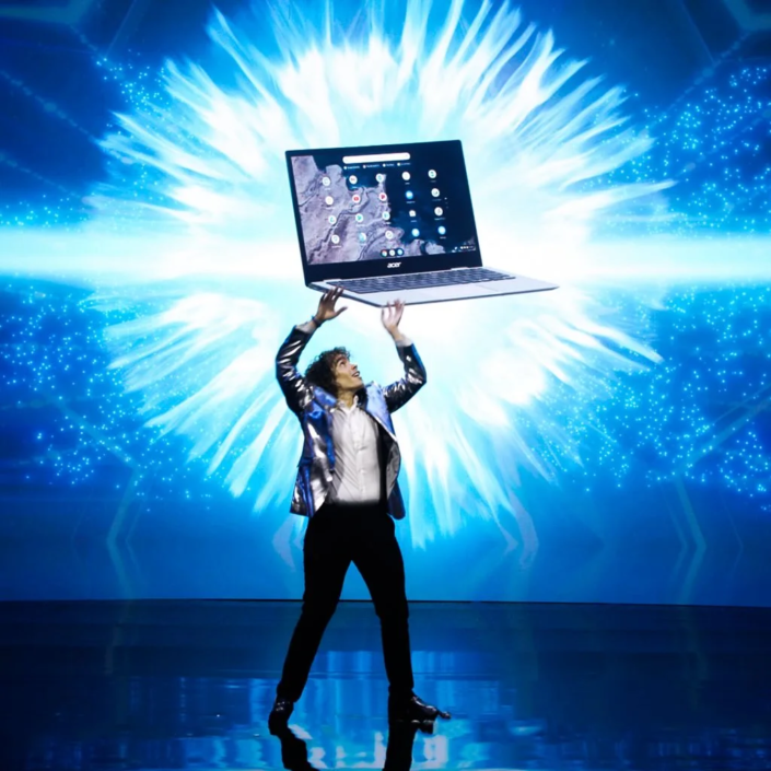 Digital magician creating illusions with light projections on screen.