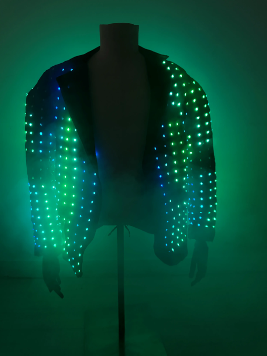 A jacket covered in green LED lights, illuminated in a dark environment.