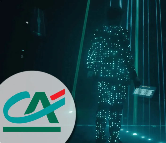 Custom AI entertainment performance featuring a performer in a light suit with a corporate logo projection for Crédit Agricole