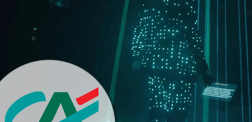 Custom AI entertainment performance featuring a performer in a light suit with a corporate logo projection for Crédit Agricole